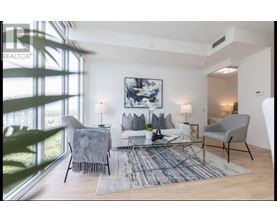 A living room with a couch, chairs, and a rug.