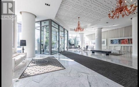 A large, open living space with a chandelier and a long hallway.