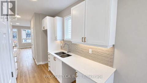 A kitchen with white cabinets and a countertop.