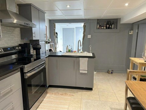 A modern kitchen with a black stove top oven and a black dishwasher.