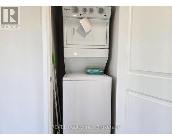 A white dishwasher is in a small kitchen.
