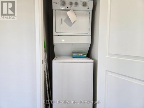 A white dishwasher is in a small kitchen.