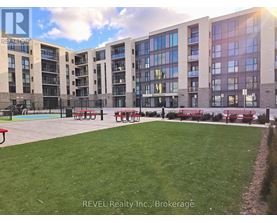 A large grassy area in front of apartment buildings.