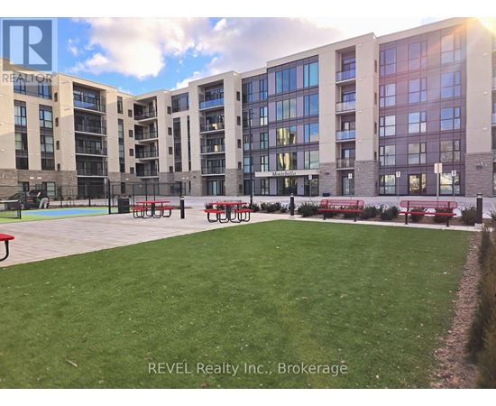 A large grassy area in front of apartment buildings.