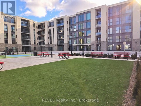A large grassy area in front of apartment buildings.