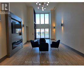 A living room with a television, chairs, and a large window.