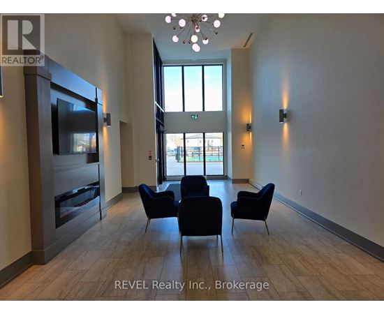 A living room with a television, chairs, and a large window.