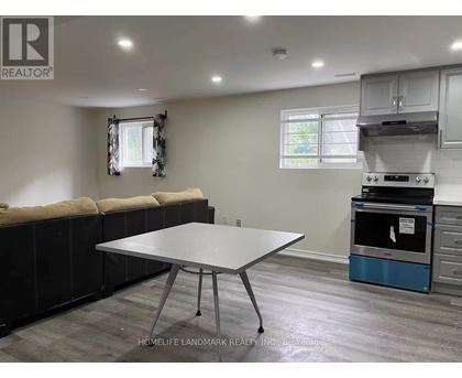 A kitchen area with a table and a stove.