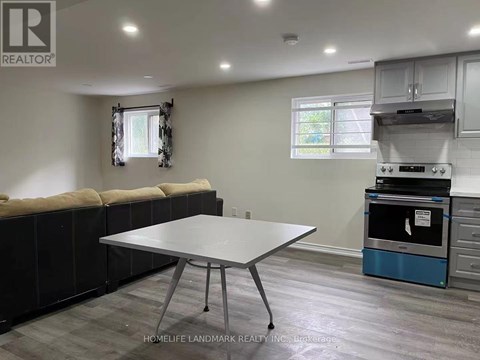 A kitchen area with a table and a stove.