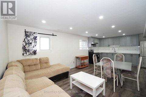 A kitchen with grey cabinets and a white countertop.