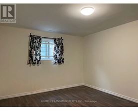 A room with a window and curtains, with the logo "REALTOR" on the wall.