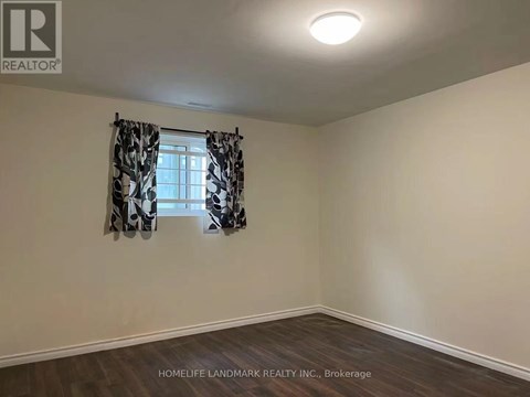A room with a window and curtains, with the logo "REALTOR" on the wall.