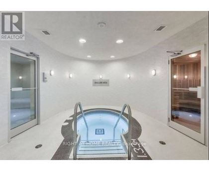 A modern indoor swimming pool with a glass bottom.