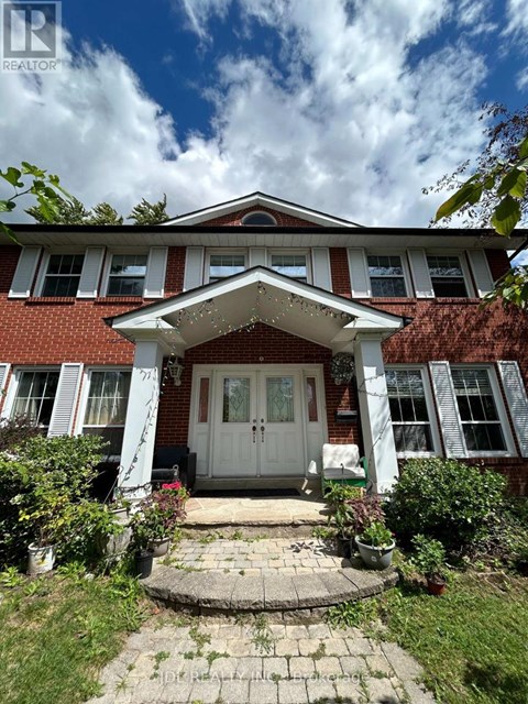 A red brick house with a white door and windows.