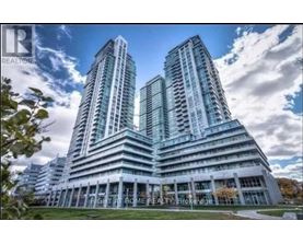 A modern building with two towers is advertised by a realtor.