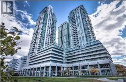 A modern building with two towers is advertised by a realtor.