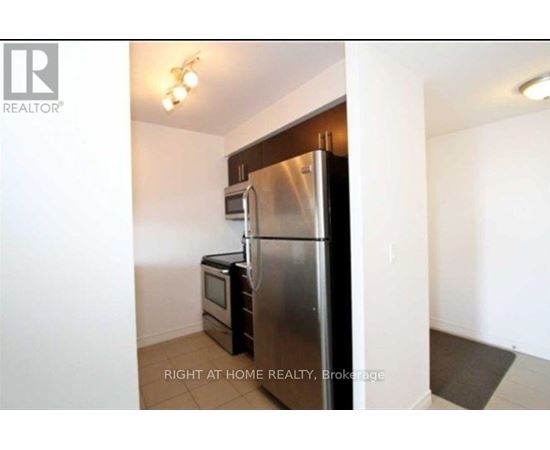A kitchen with a stainless steel refrigerator and microwave.