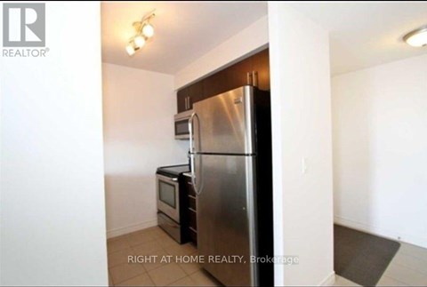 A kitchen with a stainless steel refrigerator and microwave.