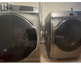 Two front load washing machines are side by side.