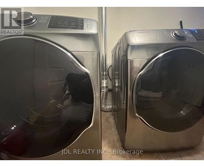 Two front load washing machines are side by side.
