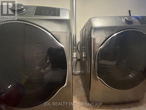 Two front load washing machines are side by side.