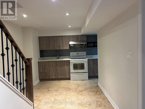 A kitchen with a stove top oven and a microwave.