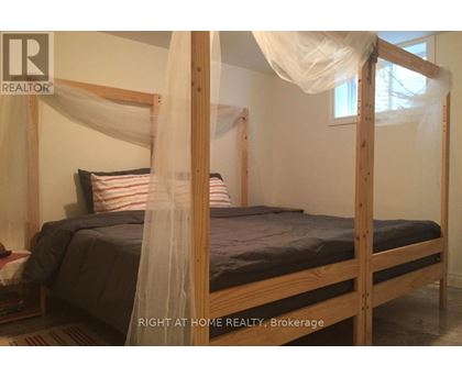 A bed with a canopy and a striped pillow is in the image.