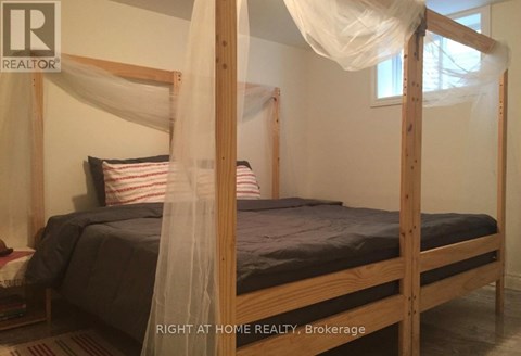 A bed with a canopy and a striped pillow is in the image.