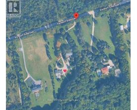A satellite image shows a property with a red marker indicating a specific location.