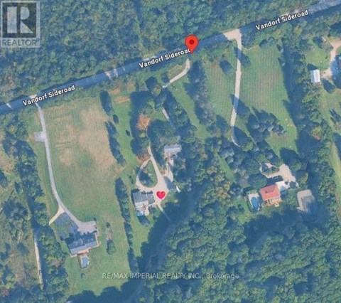 A satellite image shows a property with a red marker indicating a specific location.