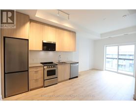A modern kitchen with wooden cabinets and stainless steel appliances.