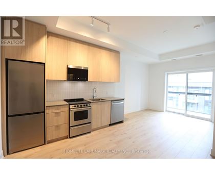 A modern kitchen with wooden cabinets and stainless steel appliances.