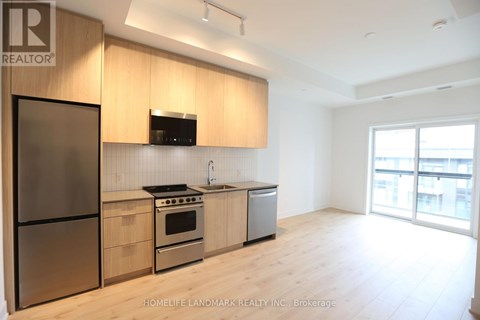 A modern kitchen with wooden cabinets and stainless steel appliances.
