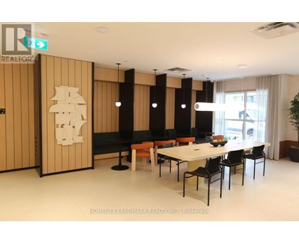 A dining room with a table and chairs.