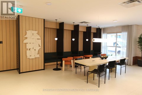 A dining room with a table and chairs.