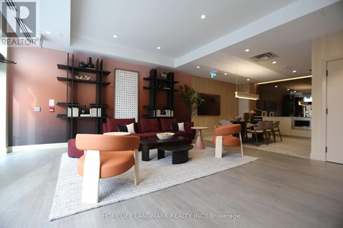 A living room with a white rug and a brown couch.