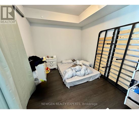 A bedroom with a bed, dresser, and wardrobe.
