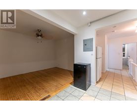 A room with wooden flooring and a flat screen TV.