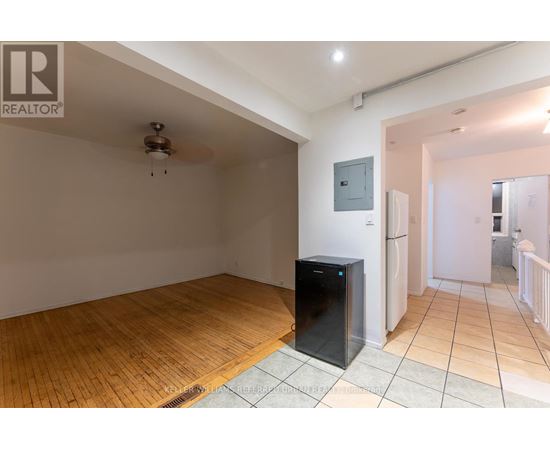 A room with wooden flooring and a flat screen TV.