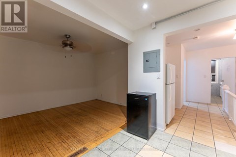 A room with wooden flooring and a flat screen TV.