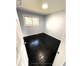 A room with a black floor and a window.