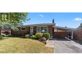 A house with a white door and a brick exterior is for sale.