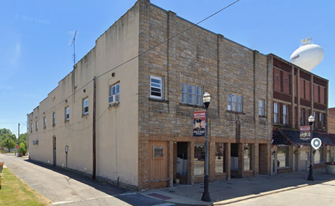 A building with a brown door and windows.