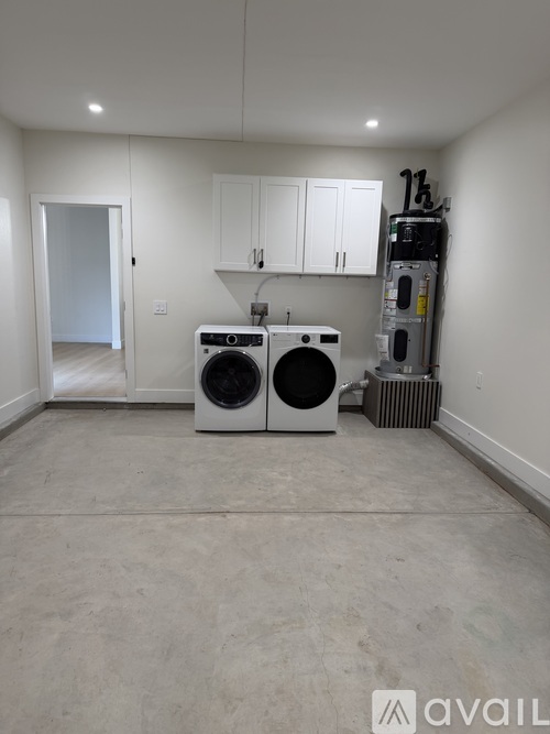 A room with a washing machine and a dryer in it.
