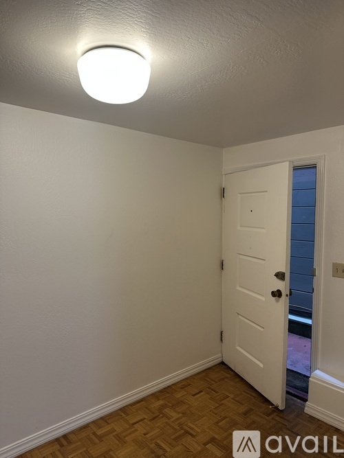 A white door with a window in the background.