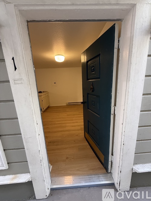 A black door is in a white frame.