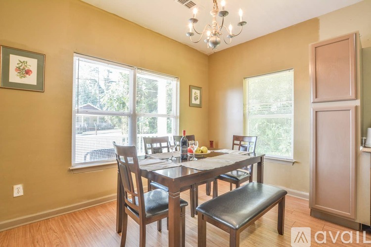A dining room with a wooden table and chairs.