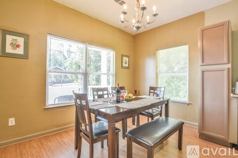 A dining room with a wooden table and chairs.