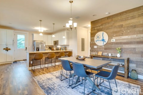 A modern kitchen with a dining table and chairs.
