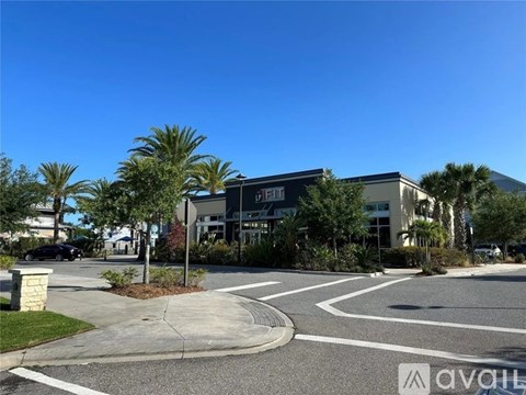 A sunny day at a roundabout with a building in the background.